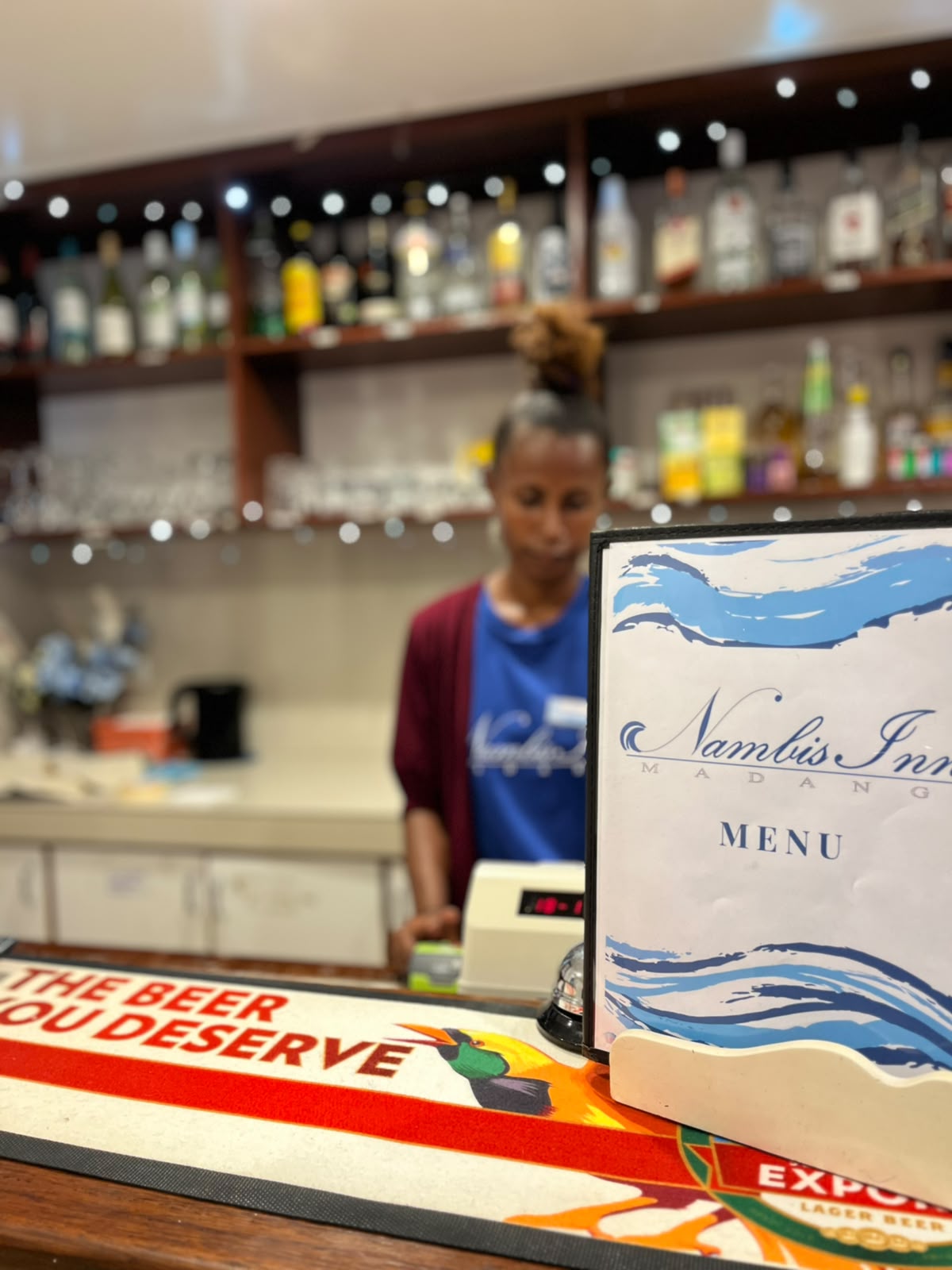 The bar with a Nambis Inn menu on the counter